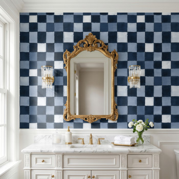 Blue checkered bathroom wallpaper with hand painted navy plaid pattern behind white vanity and gold mirror