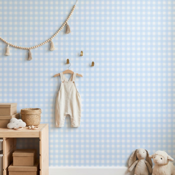 Blue checkered wallpaper in a baby boy nursery with crib and soft neutral decor