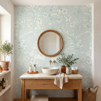 Celia Mint Botanical Wallpaper styled in a spa bathroom with wood vanity, round mirror, white vessel sink, plants, and soft mint botanical wall decor