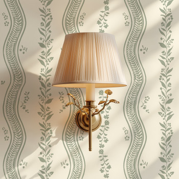 Elsie Ivory Sage green floral stripe wallpaper beside a brass wall sconce with a pleated shade, 26 inch repeat