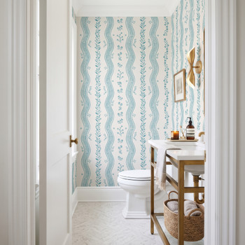 Elsie Aquamarine light teal floral stripe wallpaper over ivory in a bathroom with a wood vanity, 52 inch repeat
