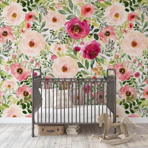 Jessica pink and red watercolor floral wallpaper in a nursery with a black metal crib and wooden rocking horse