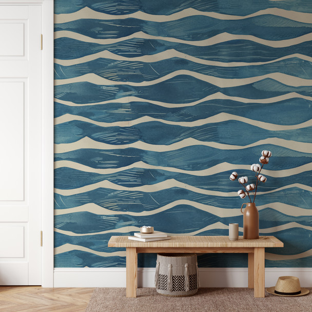 Coastal blue wave embossed wallpaper in an entryway with natural wood bench and warm ivory trim