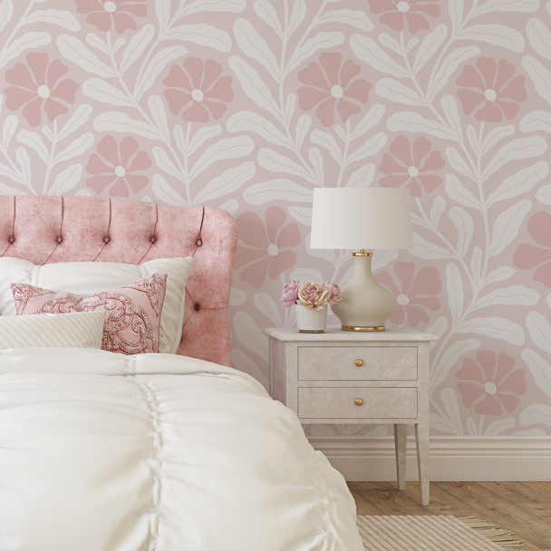 Large scale abstract pink floral wallpaper in a bright bedroom accent wall