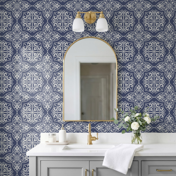 Navy blue geometric tile wallpaper in 26-inch repeat in a modern French bathroom with arched mirror and brass sconces