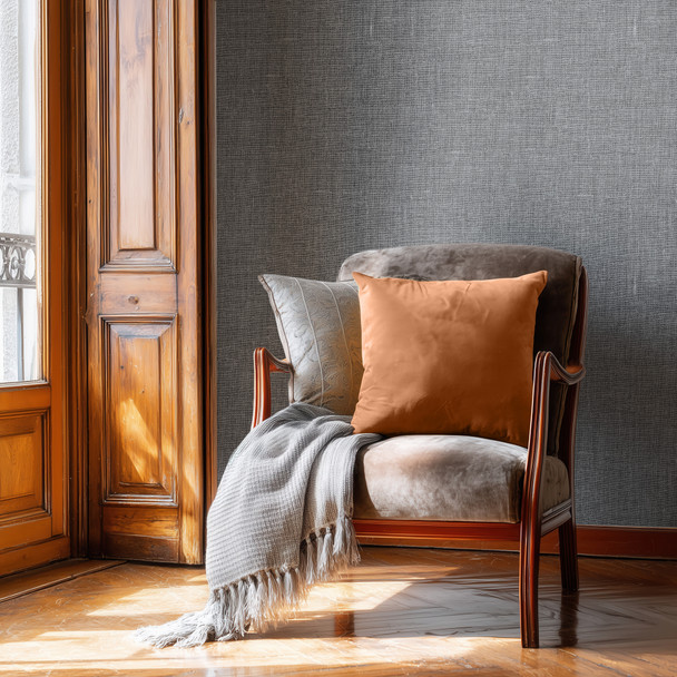 Masculine grey wallpaper in a sitting area with leather chair, wood trim, and warm sunlight