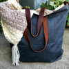 Light Blue waxed canvas messenger bag featuring premium 10oz cotton duck fabric. Eco-friendly wax coating repels water and gives this handmade bag a classic, vintage look.
