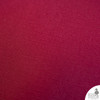 Close-up of Beet Red cotton duck texture — rich crimson tone and tight, plainweave surface.