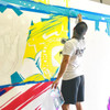Artist Painting On Large Painting Canvas 