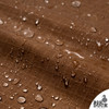 Detailed macro of 10oz cotton ripstop fabric in rich Coyote Brown, highlighting the water-repellent wax coating and distinctive grid texture