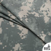 Digital camo nylon ripstop fabric folded in layered stacks showing lightweight polyurethane-coated tactical fabric texture.