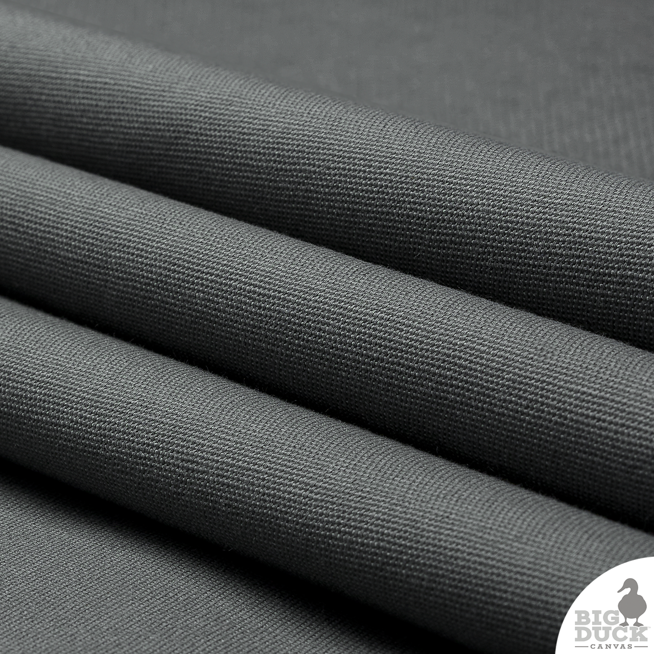 Folded cotton canvas fabric in charcoal grey ideal for cornhole bags, and sewing workrooms