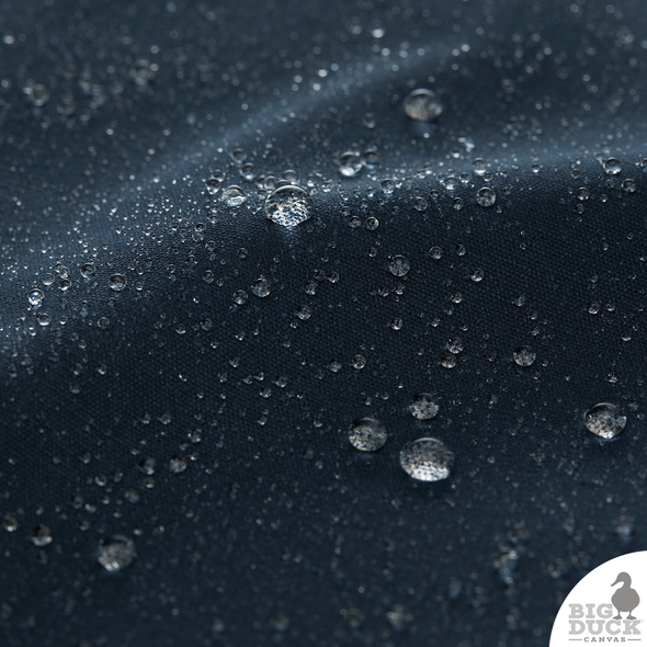 Water droplets beading on Sailor Blue Waxed Canvas Fabric — waterproof, eco-friendly cotton duck for bags and gear
