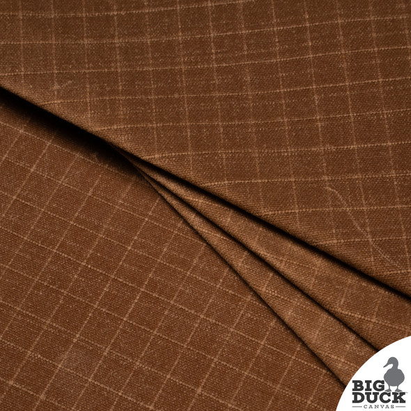 Folded Coyote Brown waxed canvas ripstop fabric stack demonstrating flexible structure and medium weight for bag making and apparel Folded Coyote Brown waxed canvas ripstop fabric stack demonstrating flexible structure and medium weight for bag making and apparel