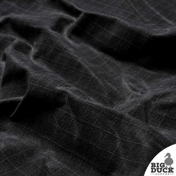 Close view of ripstop weave pattern in black waxed canvas, emphasizing reinforced tear-resistant grid and vintage look.