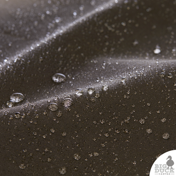 Water beading on Olive Drab Waxed Canvas — waterproof and durable finish