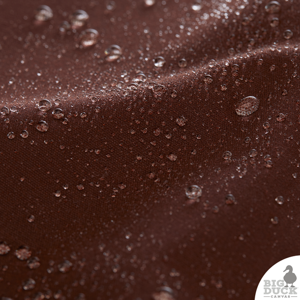 Water droplets beading on Saddle Brown Waxed Canvas Fabric — naturally water-repellent cotton canvas treated with non-toxic eco wax