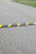 Innoplast 6' Black Rubber Speed Bump with Yellow Stripes and Cat-Eye Reflectors, 72" L x 12" W x 2" H - hardware not included (4 holes, 55lbs each)