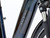 Stylish Night Blue Raleigh Motus eBike featuring integrated lighting, mudguards and a sleek low-step aluminium frame.
