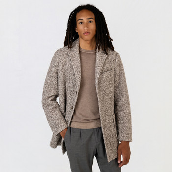 Man wearing a crew neck sweater with a knit sherpa car coat.