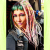 Caitlin wearing synthetic dreads in Bright Lilac, Candyfloss, Light Denim, Mojito, Icy Blue, and Lime Delight