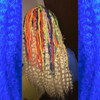 Faux locs using Red, Orange, Yellow, Neon Lemon Lime, Navy Blue, and Powder Pink marley braid, installed by Bre'Shell