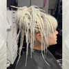 Pamela wearing dreads made from 60 Silver White, 1001/613 Creamy Blond, and Snow White