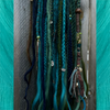 Synthetic dreads and braids made by Loveslavishlocks in Fern, Light Pine, Myrtle Green, Lagoon Blue, Night Sky, Olive Green, and Tropical Blue