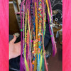 Synthetic dreads by Magick Mel in Citrus Orange, Grass Green, Hot Purple, Neon Pink, Neon Rainbow, and Neon Yellow