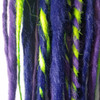 Synthetic dreads made by Amber Blue in Muted Purple, Space Cadet, and Neon Lemon Lime