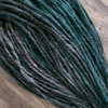 Synthetic dreads made by Amber in 1 Black, 51 Grey, and Light Pine