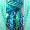 Monika wearing marley braid in Lime Green, Petrol Green, Sky Blue, and Turquoise