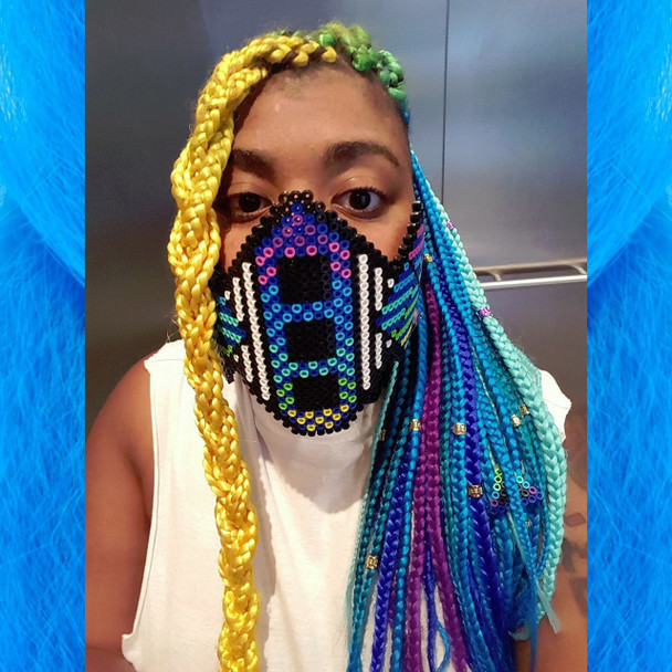 Momo Pixel wearing braids in Turquoise, Purple, Cobalt Blue, Yellow, Lime Green, Sky Blue, and Seafoam Ombré