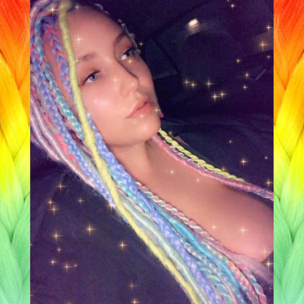 Alison wearing a mix of braids, twists, and wrapped dreads made from Mood Braid in Ice Sickle, Icy Blue, Italian Ice, and Pink Lemonade, and Festival Braid in Neon Pink, Candyfloss, Mojito, Pale Blue, Pastel Blue, Pure White, Rainbow, Sea Lavender, and Snow Pink