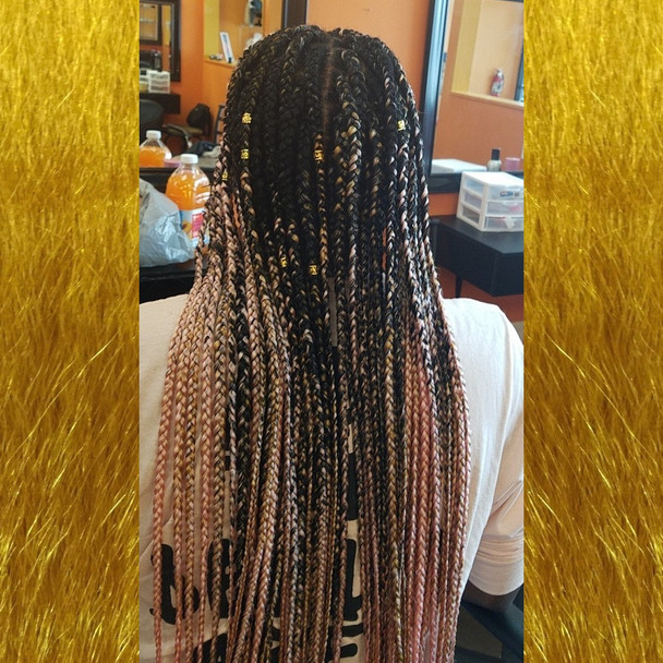August wearing braids in 1B Off Black, 144 Gold, and Pastel Pink