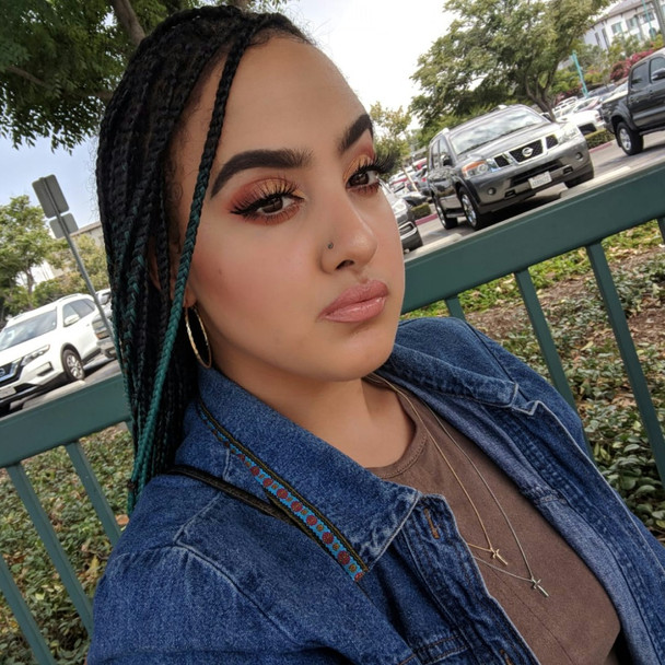 Lauryn wearing braids made from 1B Off Black with Ocean Green Tips