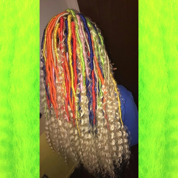 Faux locs using Red, Orange, Yellow, Neon Lemon Lime, Navy Blue, and Powder Pink marley braid, installed by Bre'Shell