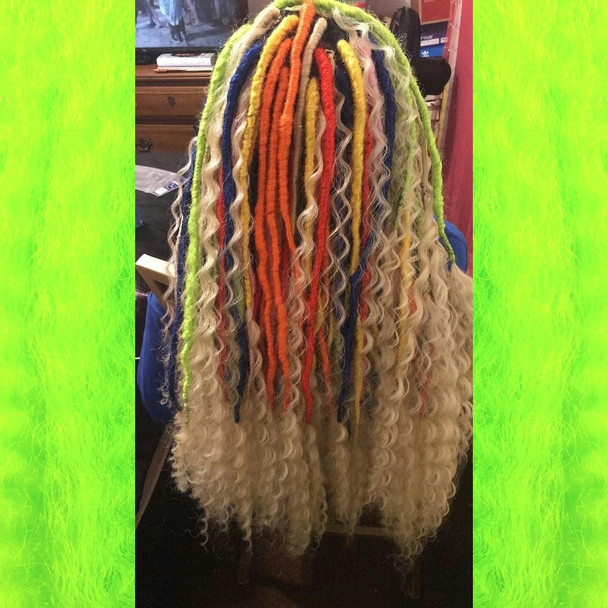 Faux locs using Red, Orange, Yellow, Neon Lemon Lime, Navy Blue, and Powder Pink marley braid, installed by Bre'Shell