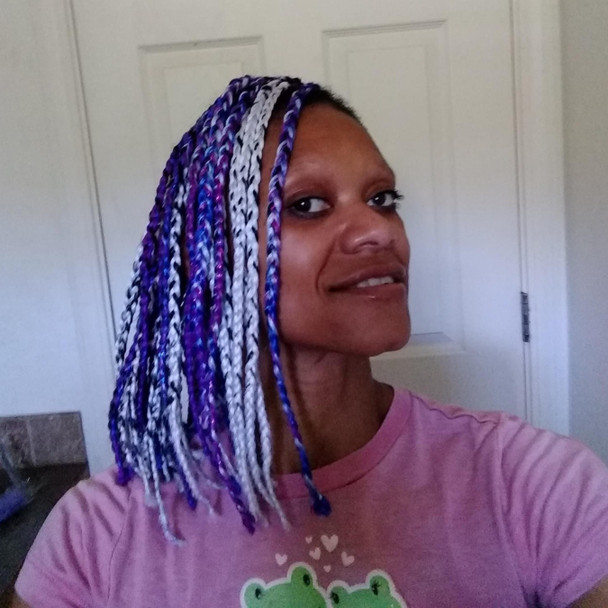 Jewelz wearing braids in Cobalt Blue, Periwinkle Blue, Sapphire Blue, Highlight Braid in 1B with Navy Blue Tips, Glow Braid in White Cotton Candy, and Festival Braid in Amethyst and Neon Purple