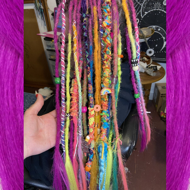 Synthetic dreads by Magick Mel in Citrus Orange, Grass Green, Hot Purple, Neon Pink, Neon Rainbow, and Neon Yellow