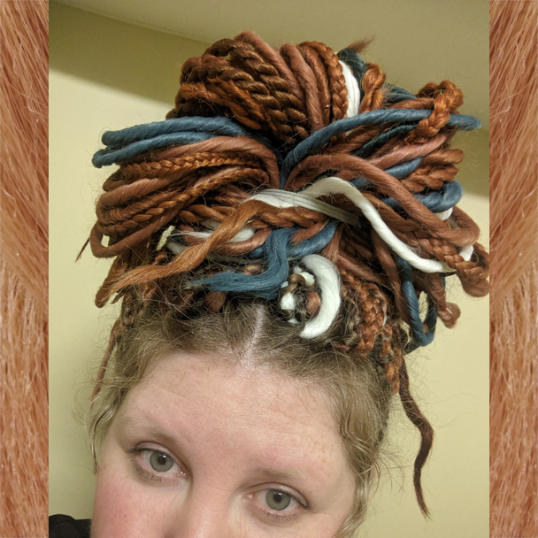 Brooke wearing synthetic dreads made from Copper, Denim Blue, Persian Orange, Pure White, and Toffee
