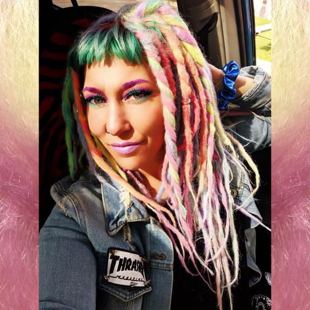 Caitlin wearing synthetic dreads in Icy Blue, Lime Delight,  Bright Lilac, Candyfloss, Light Denim, and Mojito