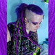 Amber Blue wearing synthetic dreads made from kanekalon in 1 Black, Neon Lemon Lime, and Neon Purple