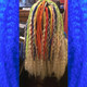 Faux locs using Red, Orange, Yellow, Neon Lemon Lime, Navy Blue, and Powder Pink marley braid, installed by Bre'Shell