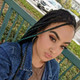 Lauryn wearing braids made from 1B Off Black with Ocean Green Tips