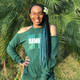 Alexia wearing braids made from 1B Off Black with Ocean Green Tips