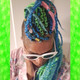 Monika wearing marley braid in Lime Green, Petrol Green, Sky Blue, and Turquoise