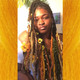 Faux locs by Shaymon in Banana Split, Burnt Orange, Neon Tangerine, Olive Green, Popcorn, Sugar Blond, and Treasure