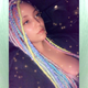 Alison wearing a mix of braids, twists, and wrapped dreads made from Mood Braid in Ice Sickle, Icy Blue, Italian Ice, and Pink Lemonade, and Festival Braid in Candyfloss, Mojito, Neon Pink, Pale Blue, Pastel Blue, Pure White, Rainbow, Sea Lavender, and Snow Pink