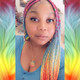 Alicia wearing rainbow cuffs on braids in Reverse Rainbow